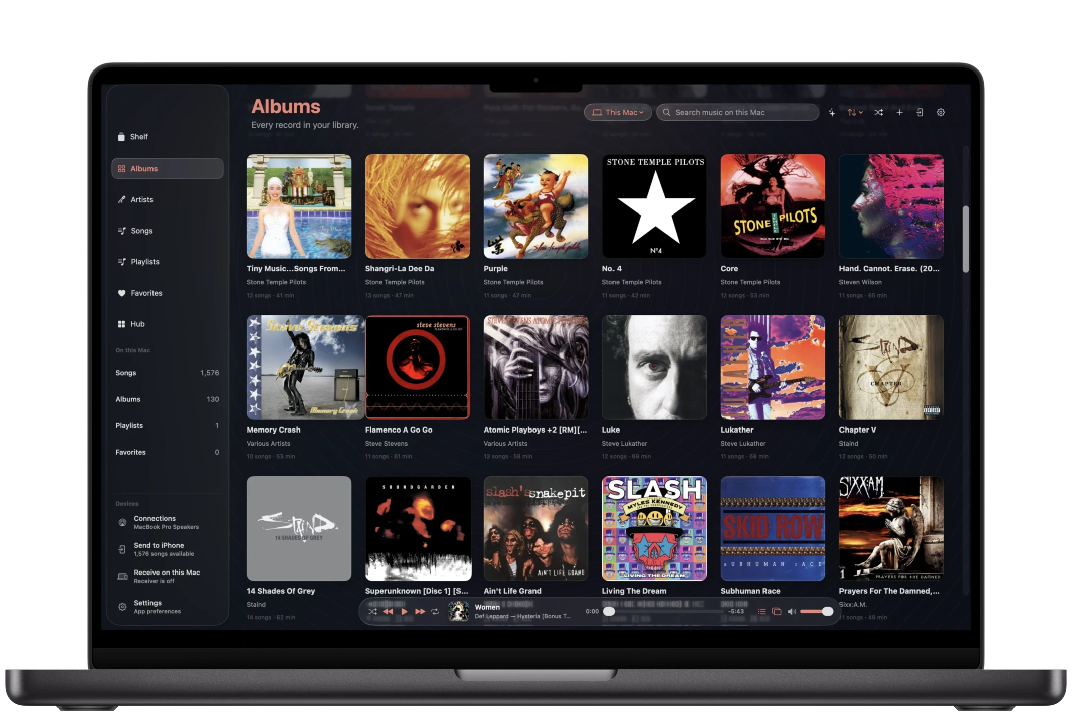 The Albums view in aud-io for Mac shown on a MacBook Pro